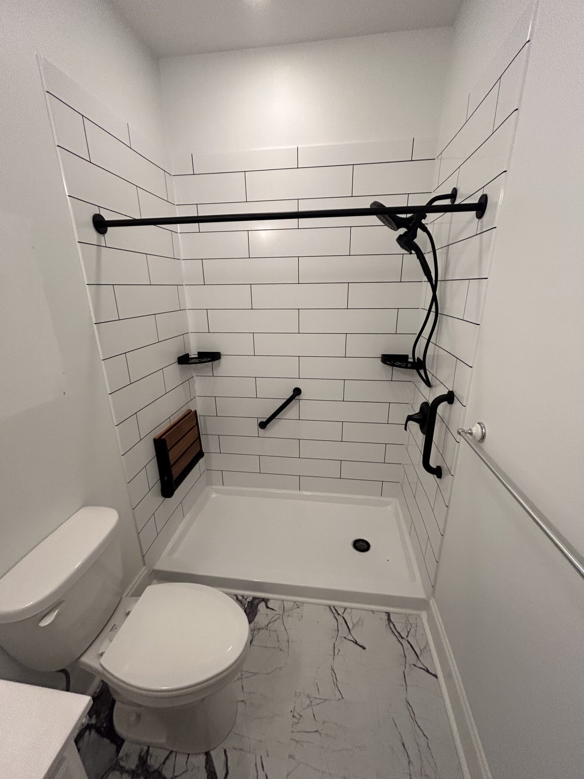 Tub-to-shower conversion mockup with bronze fixtures, Concord NC — (704) 743-3582