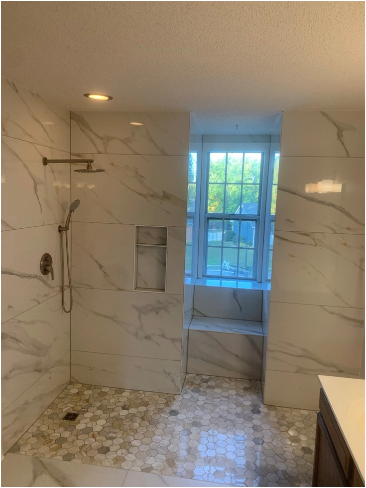 luxury walk in shower with bench and recessed niche marble tile remodel by premier hds